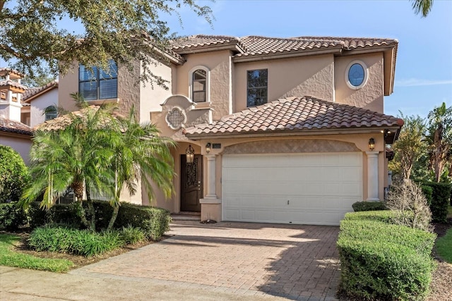 mediterranean / spanish-style home with a garage