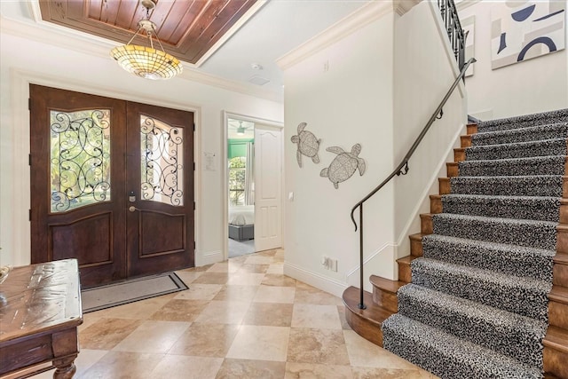 entrance foyer featuring french doors, ornamental molding, and wood ceiling