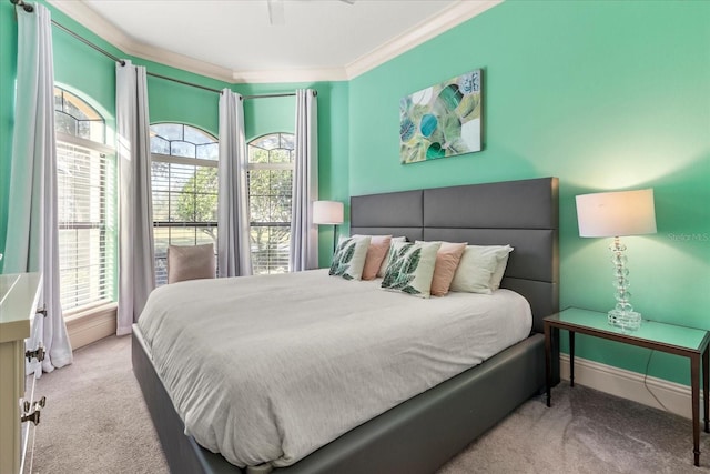 carpeted bedroom with crown molding and ceiling fan