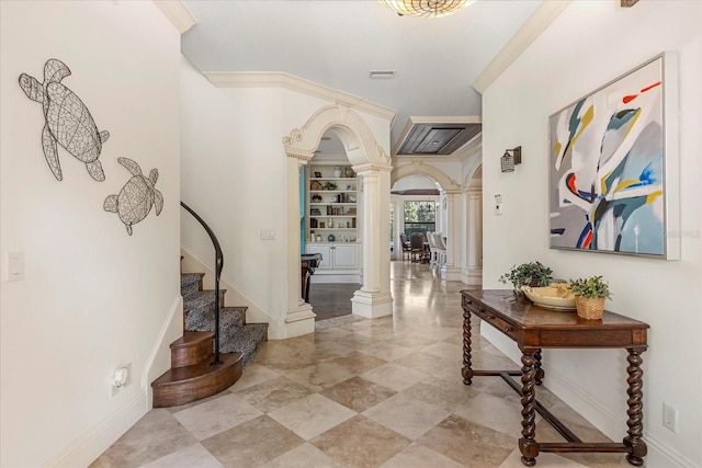 hallway featuring decorative columns, crown molding, and built in shelves