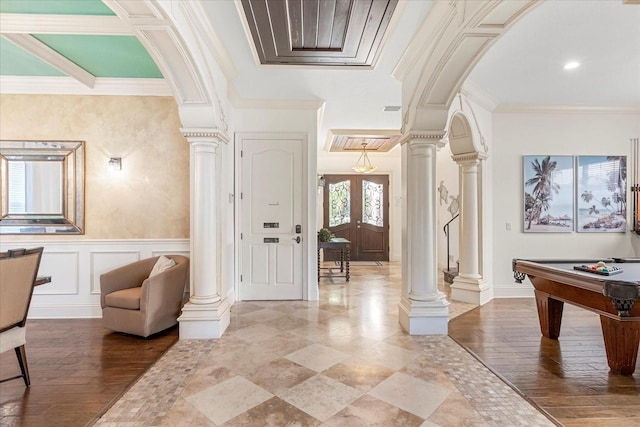 entrance foyer with pool table, crown molding, french doors, and hardwood / wood-style flooring