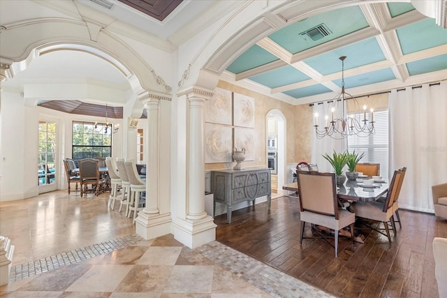 dining room with hardwood / wood-style floors, beam ceiling, a chandelier, ornamental molding, and coffered ceiling