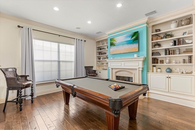 game room with crown molding, pool table, dark hardwood / wood-style floors, and built in features