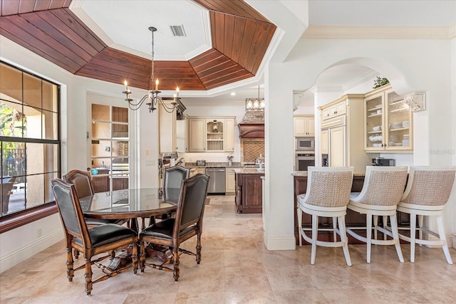 dining area featuring crown molding, wood ceiling, a chandelier, and a raised ceiling