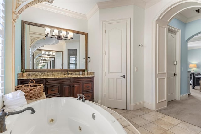 bathroom featuring vanity, crown molding, tile patterned flooring, and a washtub