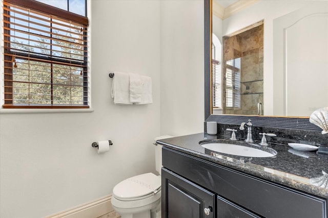 bathroom featuring vanity, a shower with shower door, ornamental molding, and toilet