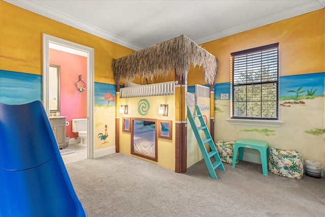 carpeted bedroom with ensuite bath and crown molding