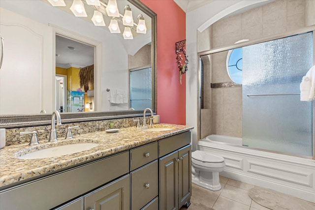 full bathroom with shower / bath combination with glass door, toilet, vanity, crown molding, and tile patterned flooring