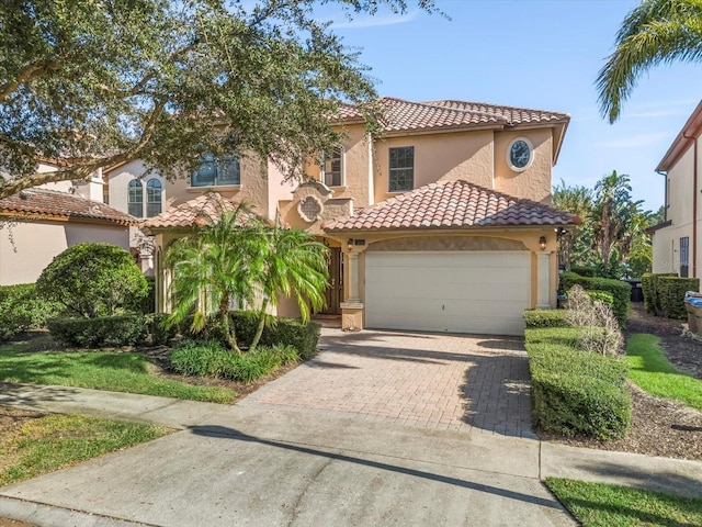 mediterranean / spanish-style house with a garage