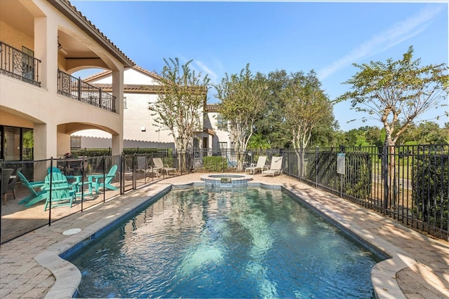 view of swimming pool with an in ground hot tub and a patio area