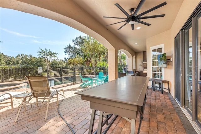 view of patio / terrace featuring ceiling fan and a swimming pool