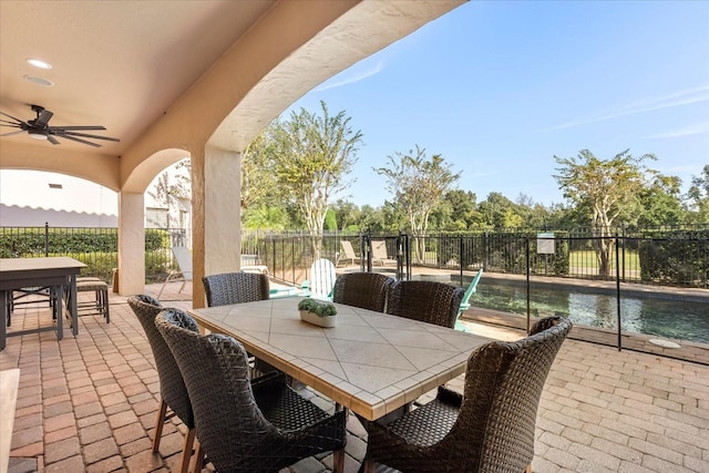 view of patio / terrace with a fenced in pool and ceiling fan