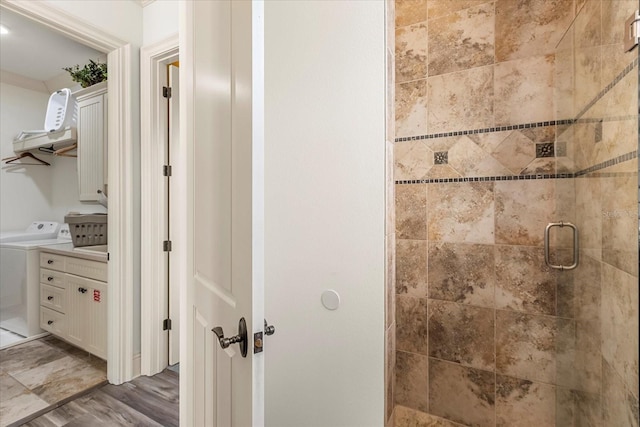 bathroom with vanity, washer / clothes dryer, walk in shower, and hardwood / wood-style floors