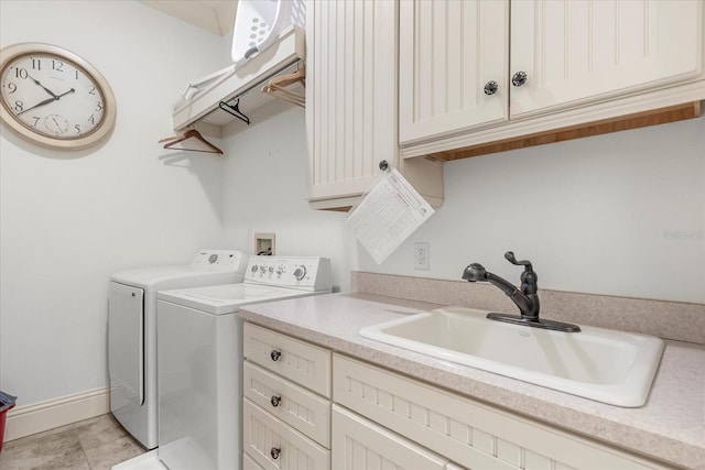 clothes washing area with cabinets, washer and dryer, sink, and light tile patterned floors