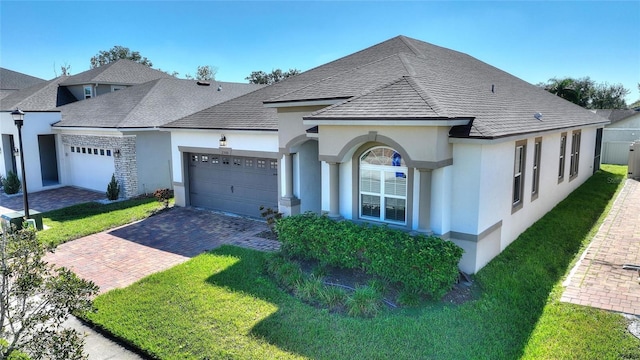 view of front of house with a front yard and a garage