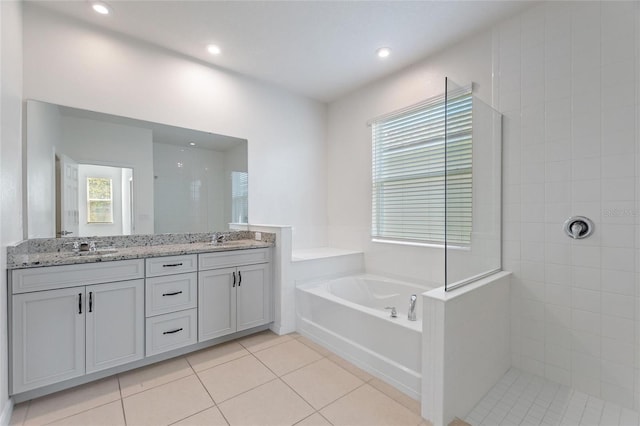 bathroom featuring vanity, shower with separate bathtub, and tile patterned floors