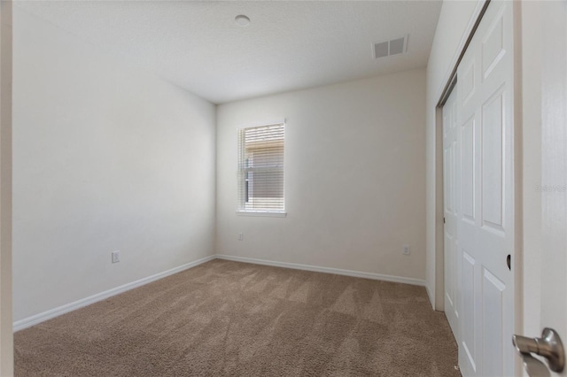 unfurnished bedroom with a closet and carpet