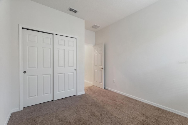 unfurnished bedroom featuring a closet and carpet