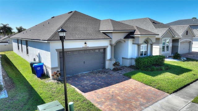 view of front of home featuring a front yard and a garage