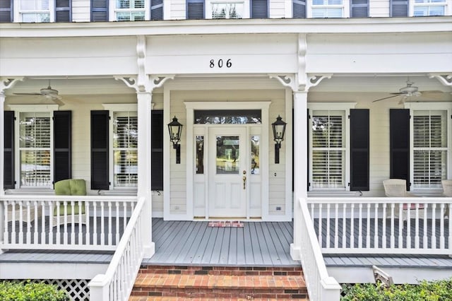 entrance to property with covered porch and ceiling fan