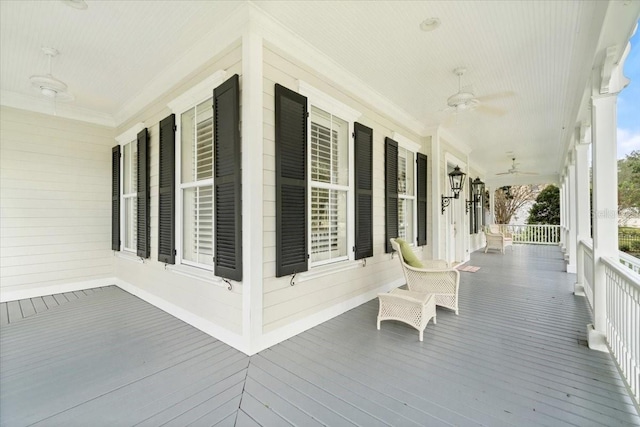 wooden terrace featuring a porch and ceiling fan