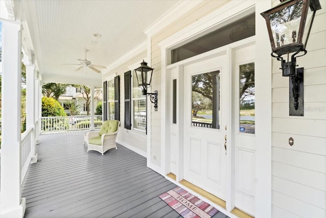 deck with covered porch and ceiling fan