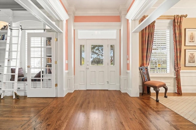 foyer entrance featuring crown molding and dark hardwood / wood-style flooring