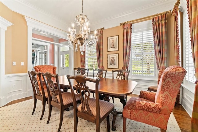 dining room with crown molding, a notable chandelier, and light wood-type flooring