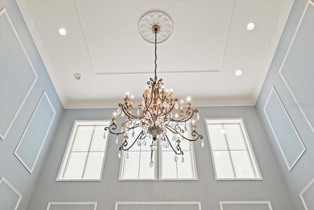 interior details featuring crown molding and a chandelier