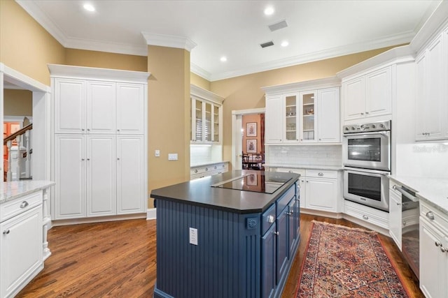 kitchen featuring a center island, dark hardwood / wood-style flooring, blue cabinets, stainless steel appliances, and white cabinets