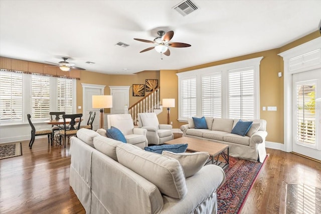 living room featuring dark hardwood / wood-style floors and ceiling fan