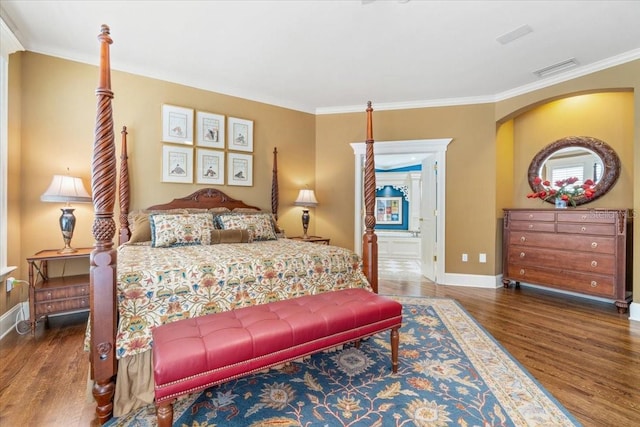 bedroom with crown molding and dark hardwood / wood-style flooring