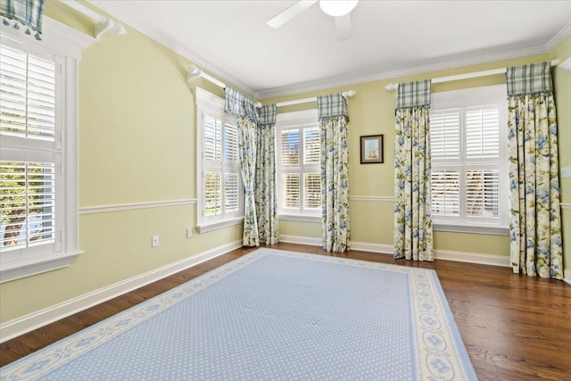 unfurnished room featuring crown molding, dark wood-type flooring, plenty of natural light, and ceiling fan