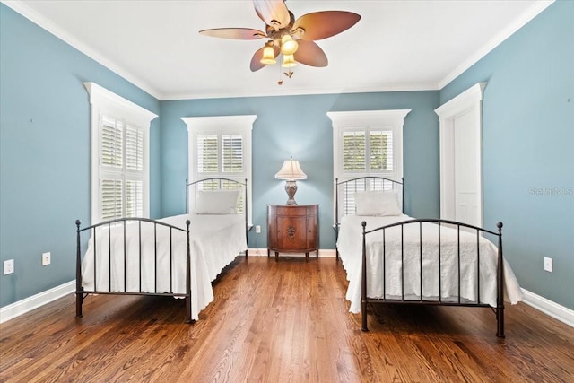 bedroom featuring ceiling fan, ornamental molding, and hardwood / wood-style floors