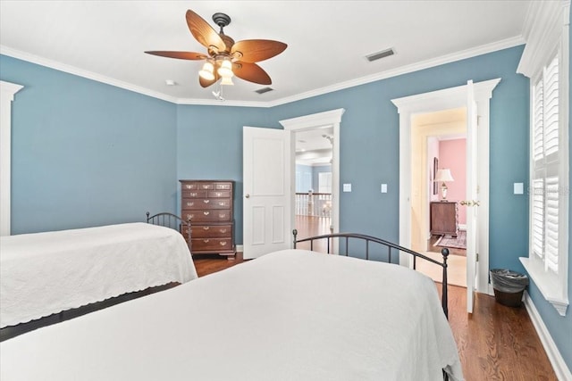 bedroom featuring ornamental molding, dark wood-type flooring, and ceiling fan