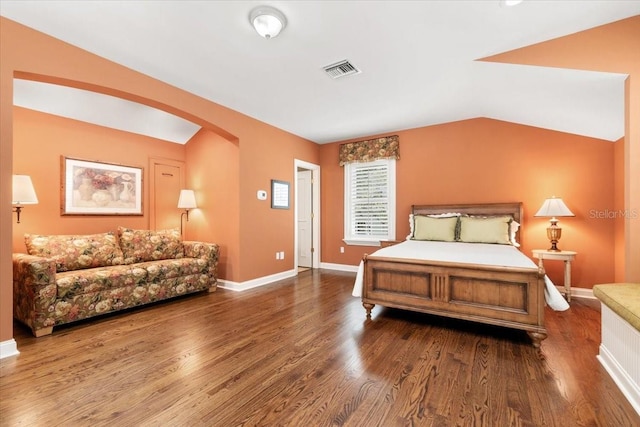 bedroom featuring lofted ceiling and dark hardwood / wood-style flooring