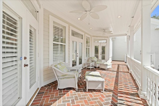 sunroom featuring french doors and ceiling fan