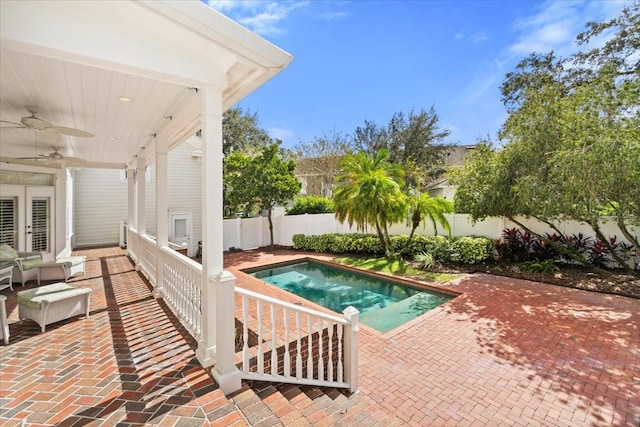 view of pool with a patio and ceiling fan