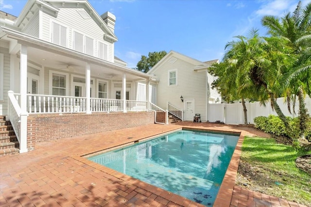 view of swimming pool featuring a patio and ceiling fan