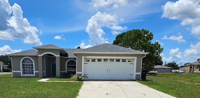 view of front facade with a front yard and a garage