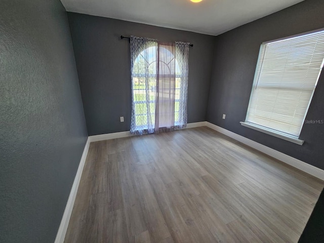 unfurnished room with light wood-type flooring