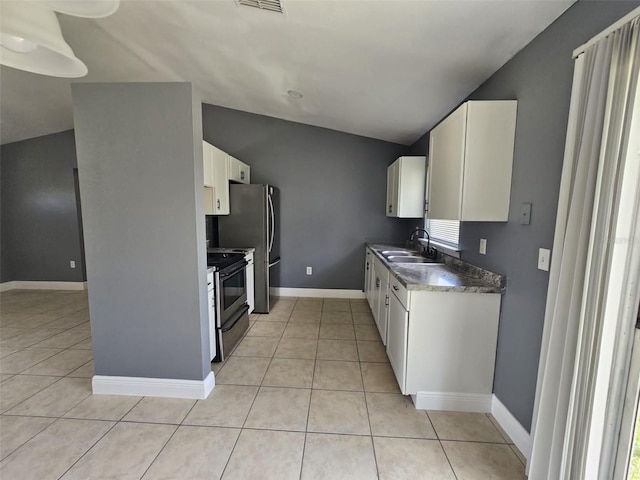 kitchen featuring lofted ceiling, white cabinets, stainless steel appliances, and sink