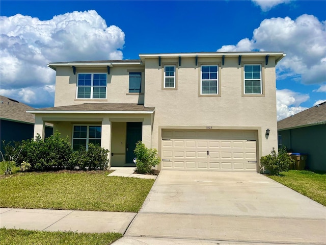 view of front of house with a front yard and a garage