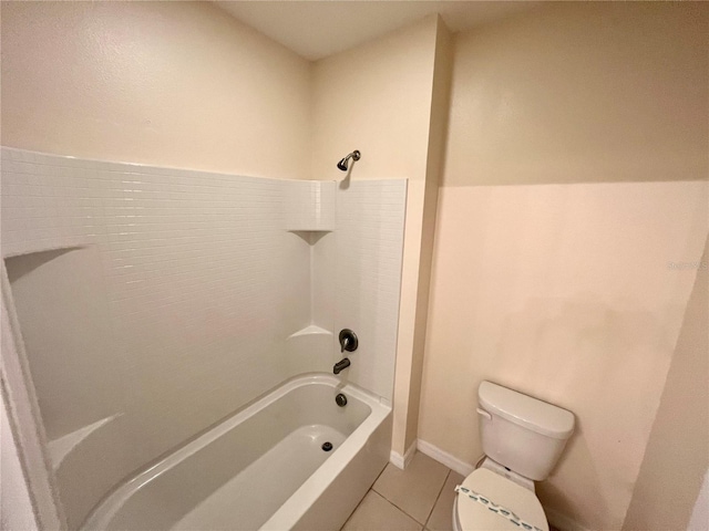 bathroom featuring tile patterned flooring, bathtub / shower combination, and toilet