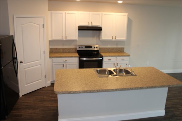 kitchen with a kitchen island with sink, black refrigerator, white cabinets, and stainless steel range with electric stovetop