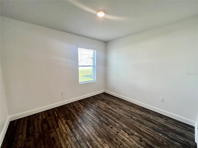 empty room featuring dark hardwood / wood-style flooring