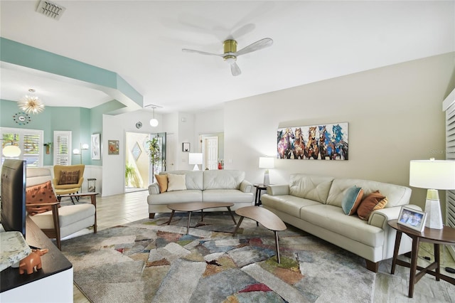 living room with wood-type flooring, plenty of natural light, and ceiling fan