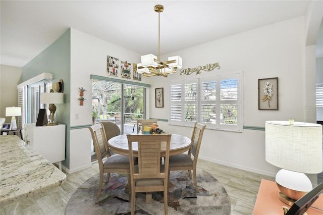 dining area featuring a notable chandelier and a wealth of natural light