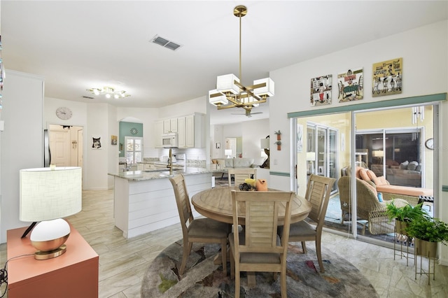 dining space with a chandelier and light hardwood / wood-style flooring