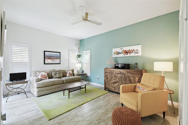 living room with light wood-type flooring and ceiling fan